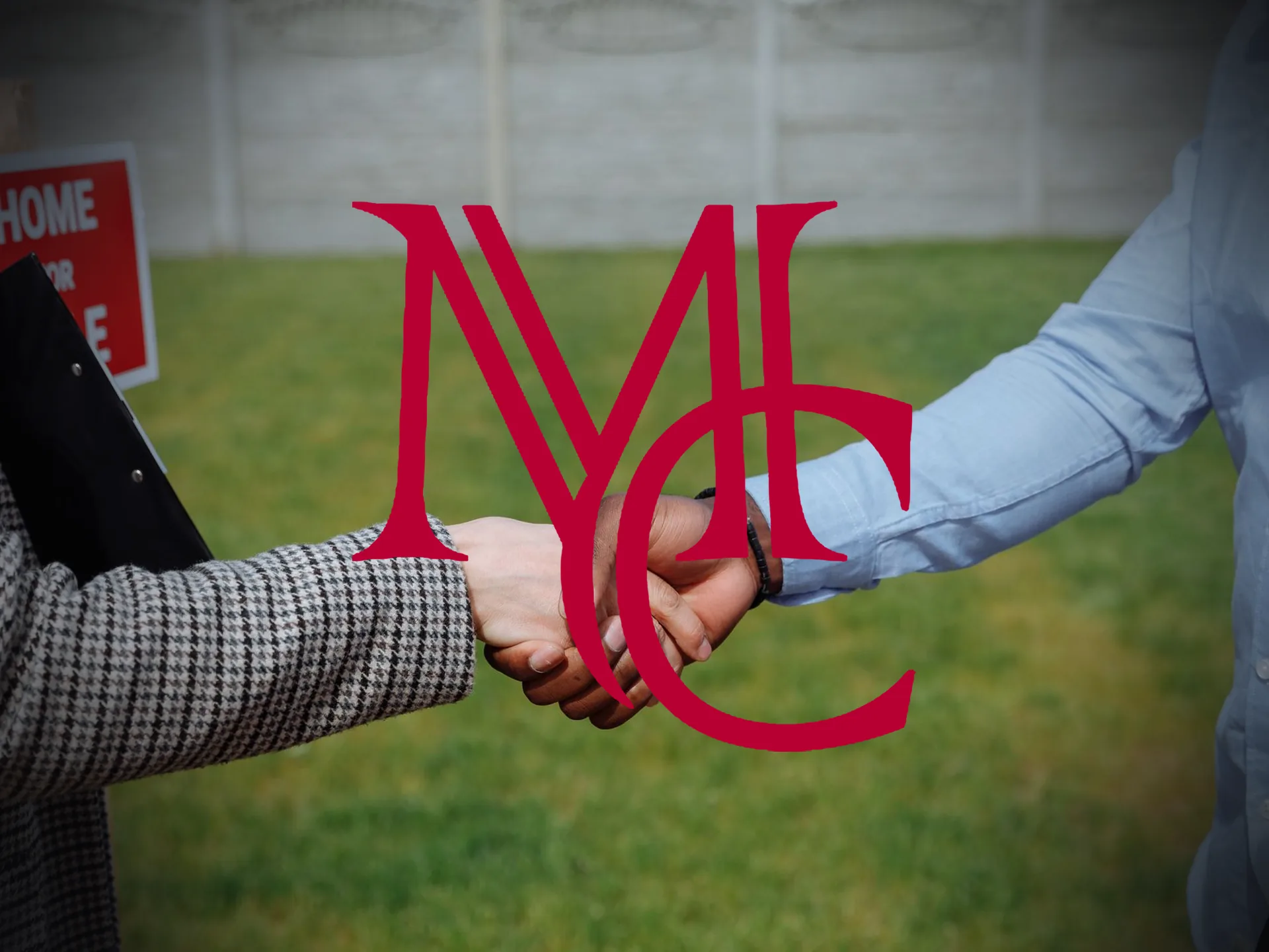 Two people shaking hands in front of a home for sale sign in a yard — MCG
