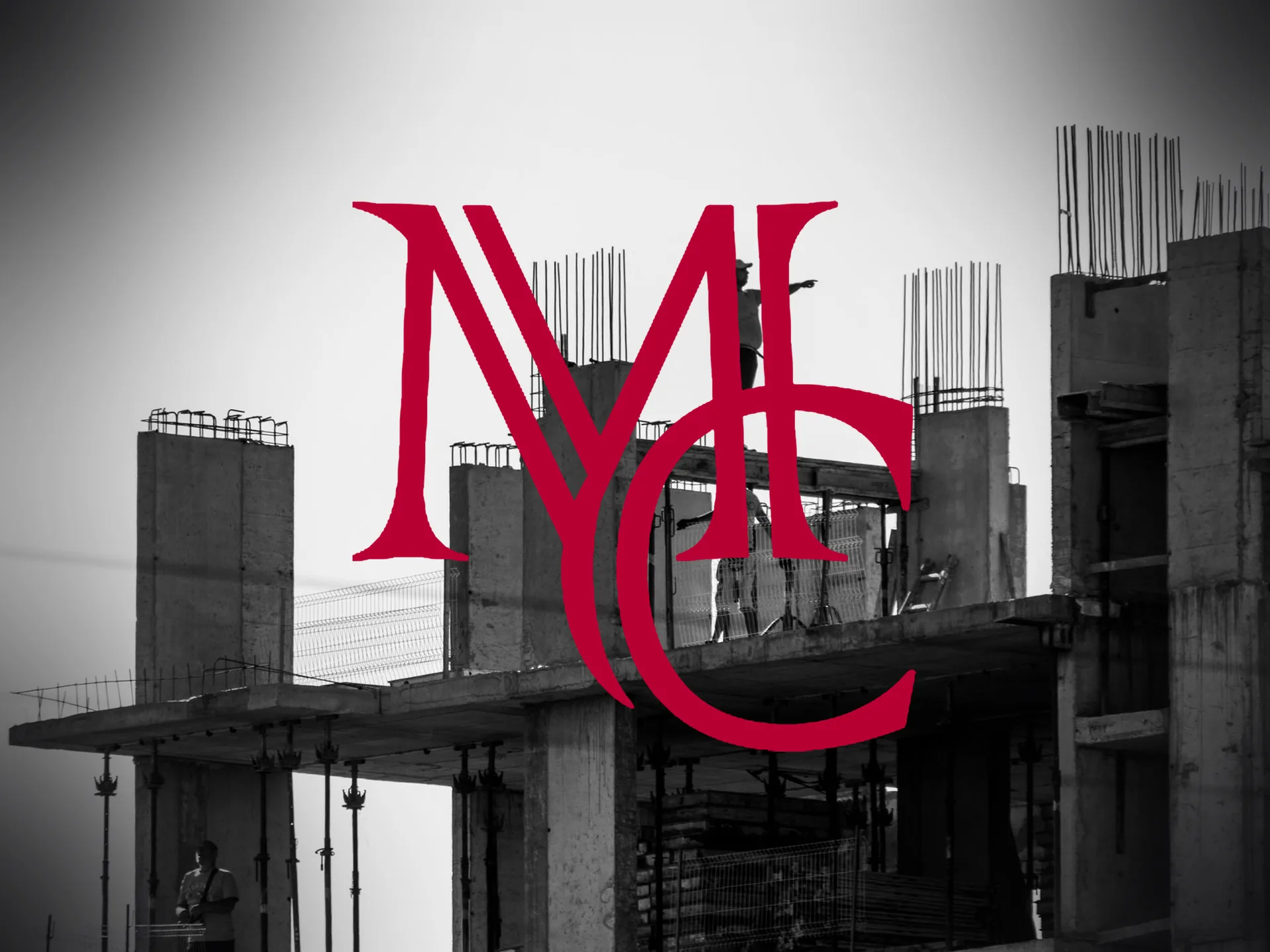 Multifamily building under construction with concrete columns, rebar and workers on site — MCG