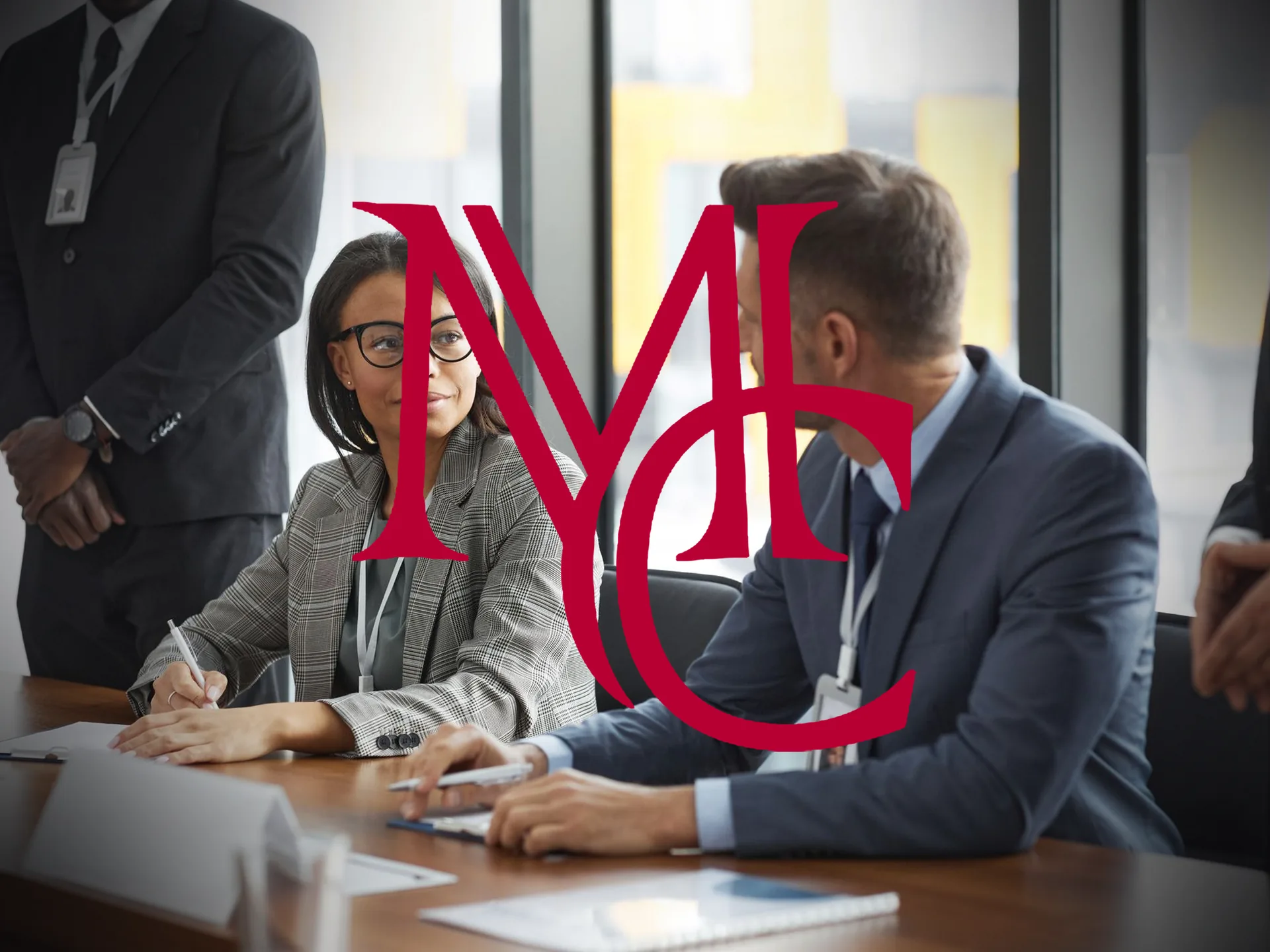 Commercial tenants and brokers reviewing lease documents at a conference table — MCG