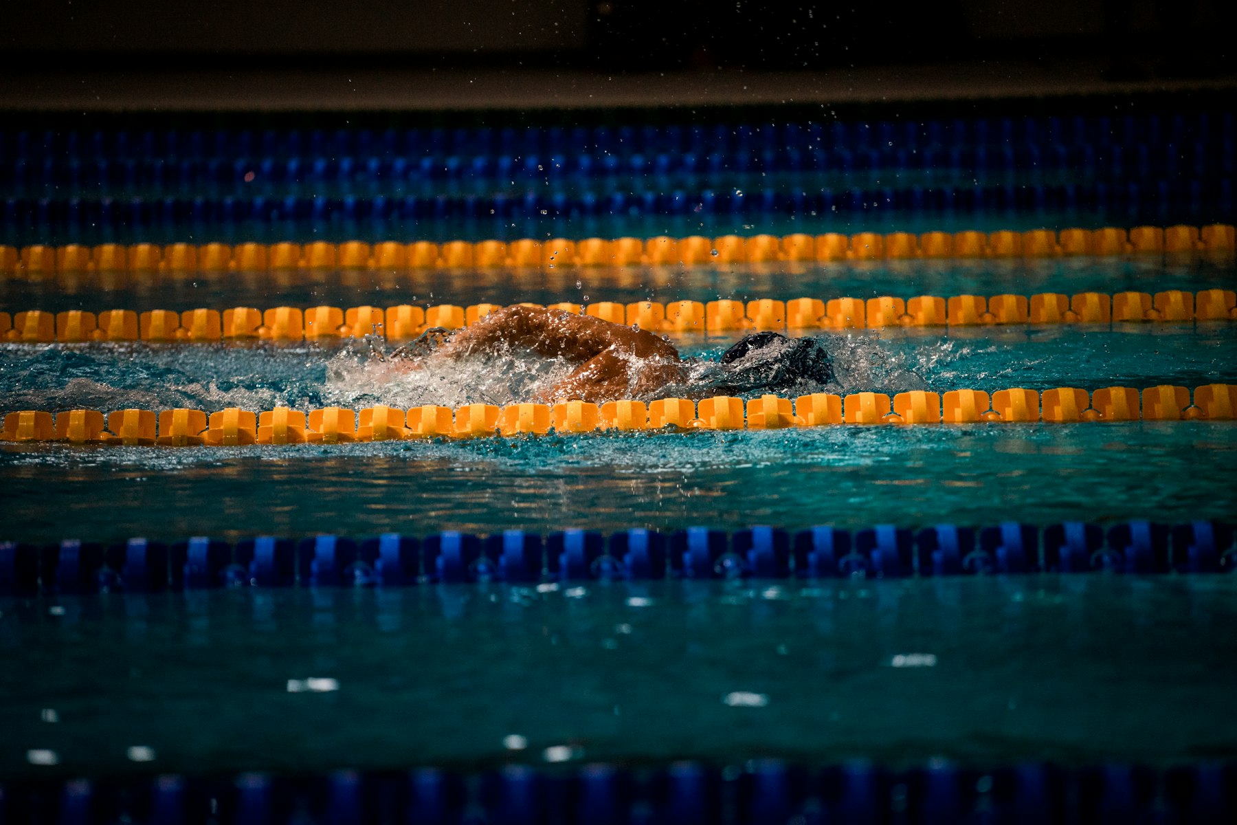 Generic stock photo of a swimmer in a lap pool with lane ropes (not the Bentonville Community Center)