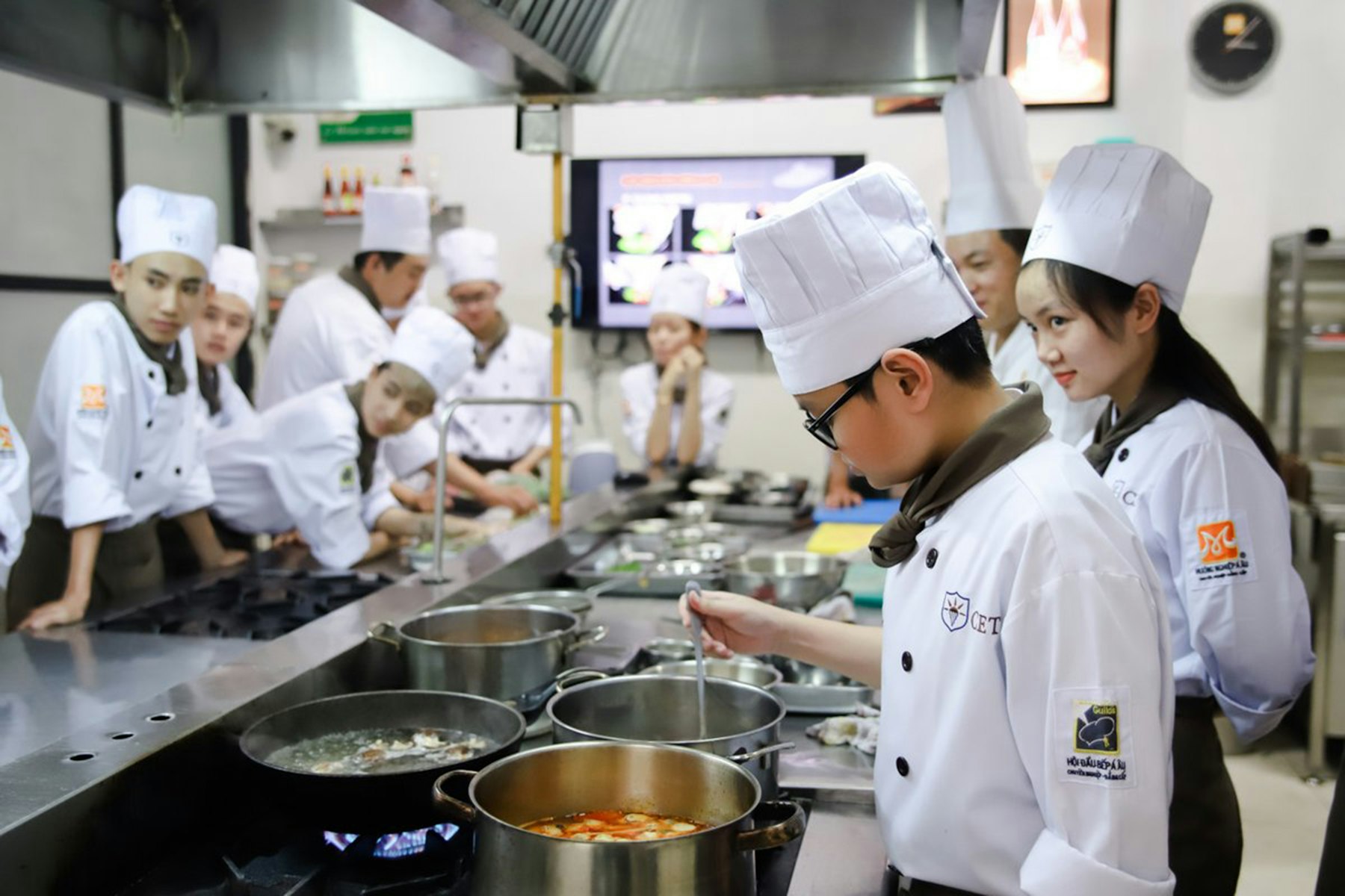 Culinary students preparing food together in a teaching kitchen (generic stock photo, not Brightwater)