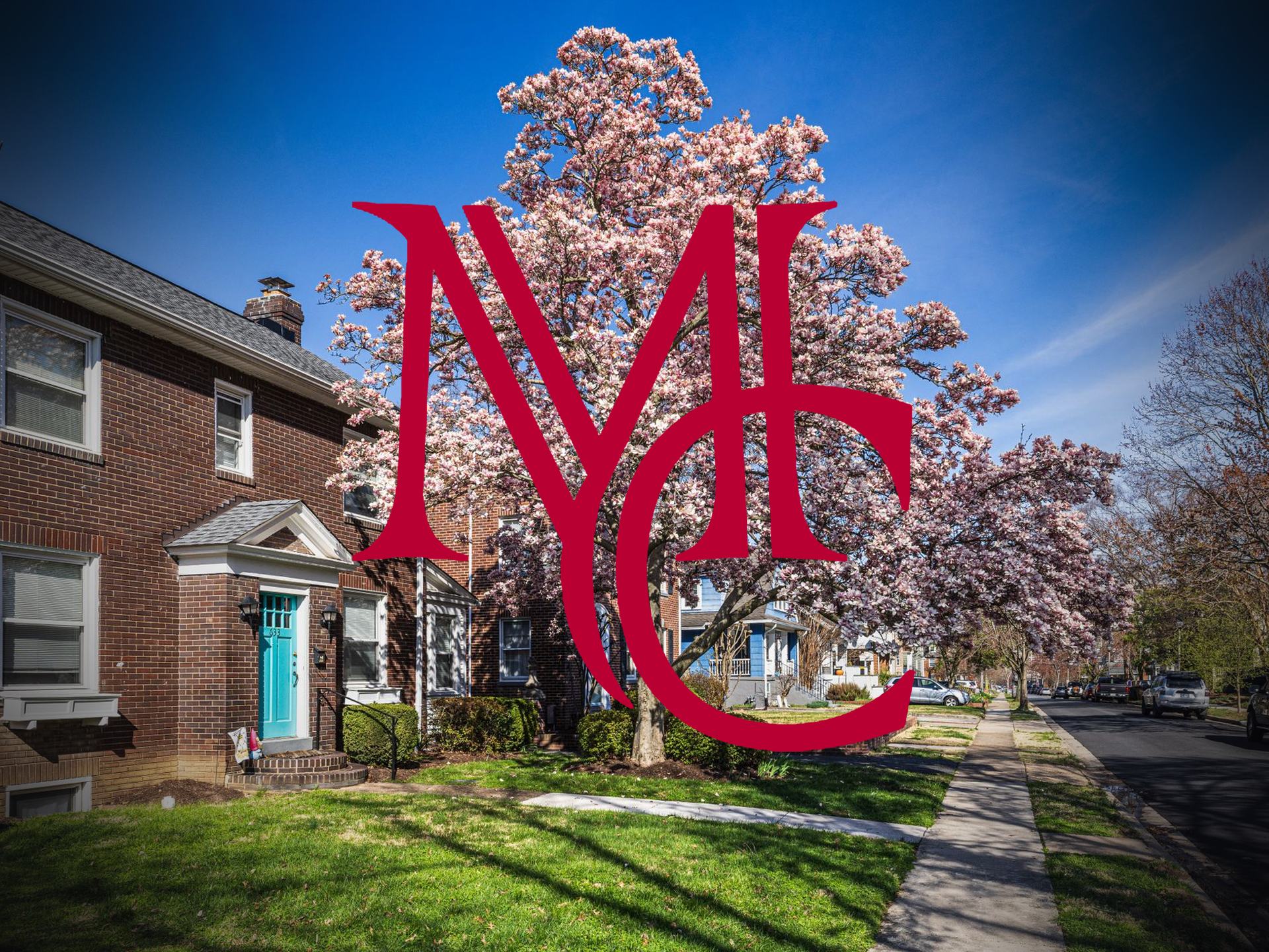 Brick house with teal door and blooming magnolia tree on a street with the crimson Mason Capital Group monogram, illustrating spring home selling