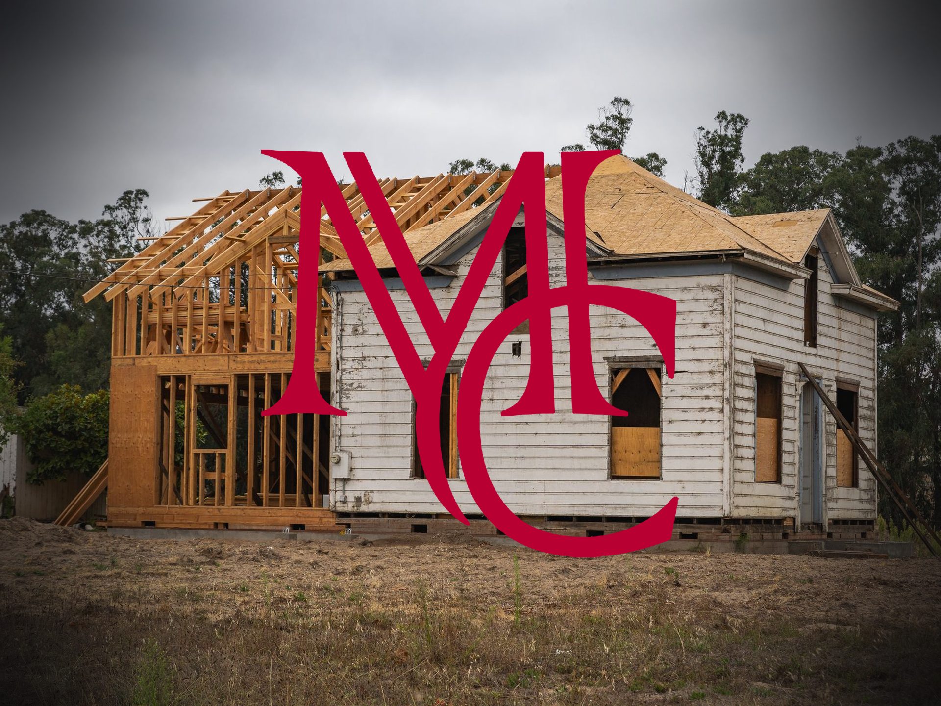 Older house with a new wood-frame addition with the crimson Mason Capital Group monogram, illustrating selling a home with an unpermitted addition