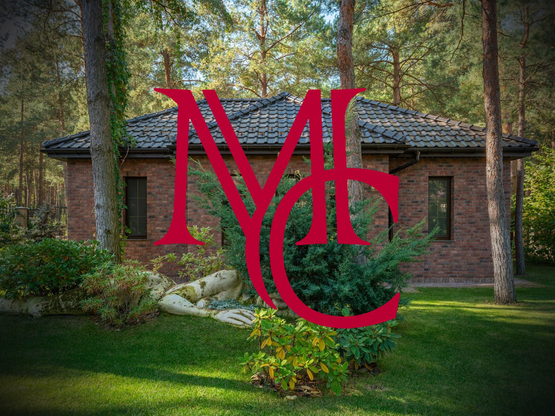 Brick house with tile roof among pine trees with the crimson Mason Capital Group monogram, illustrating selling a house with a septic system