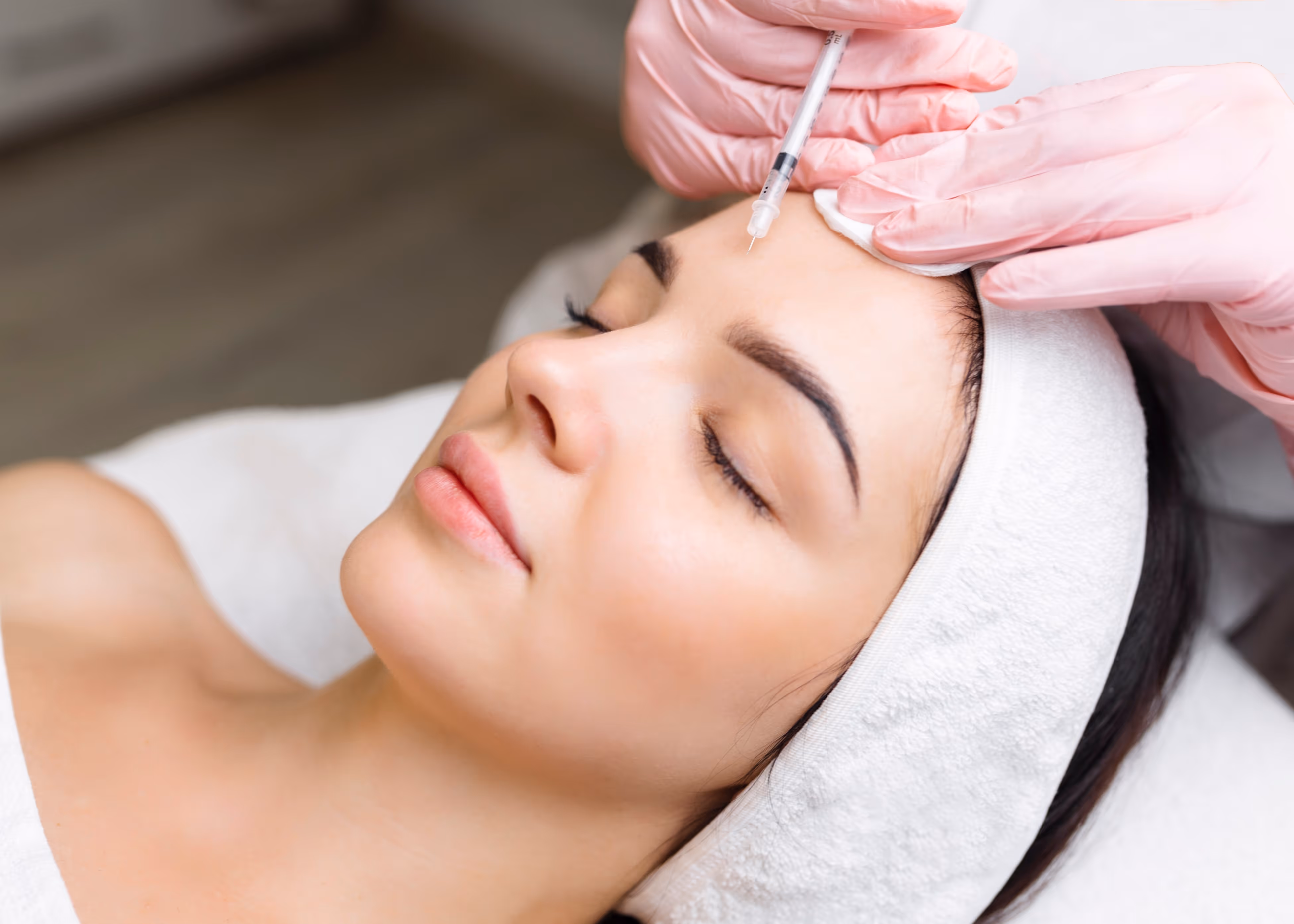 A woman getting a botilage treatment from a doctor.