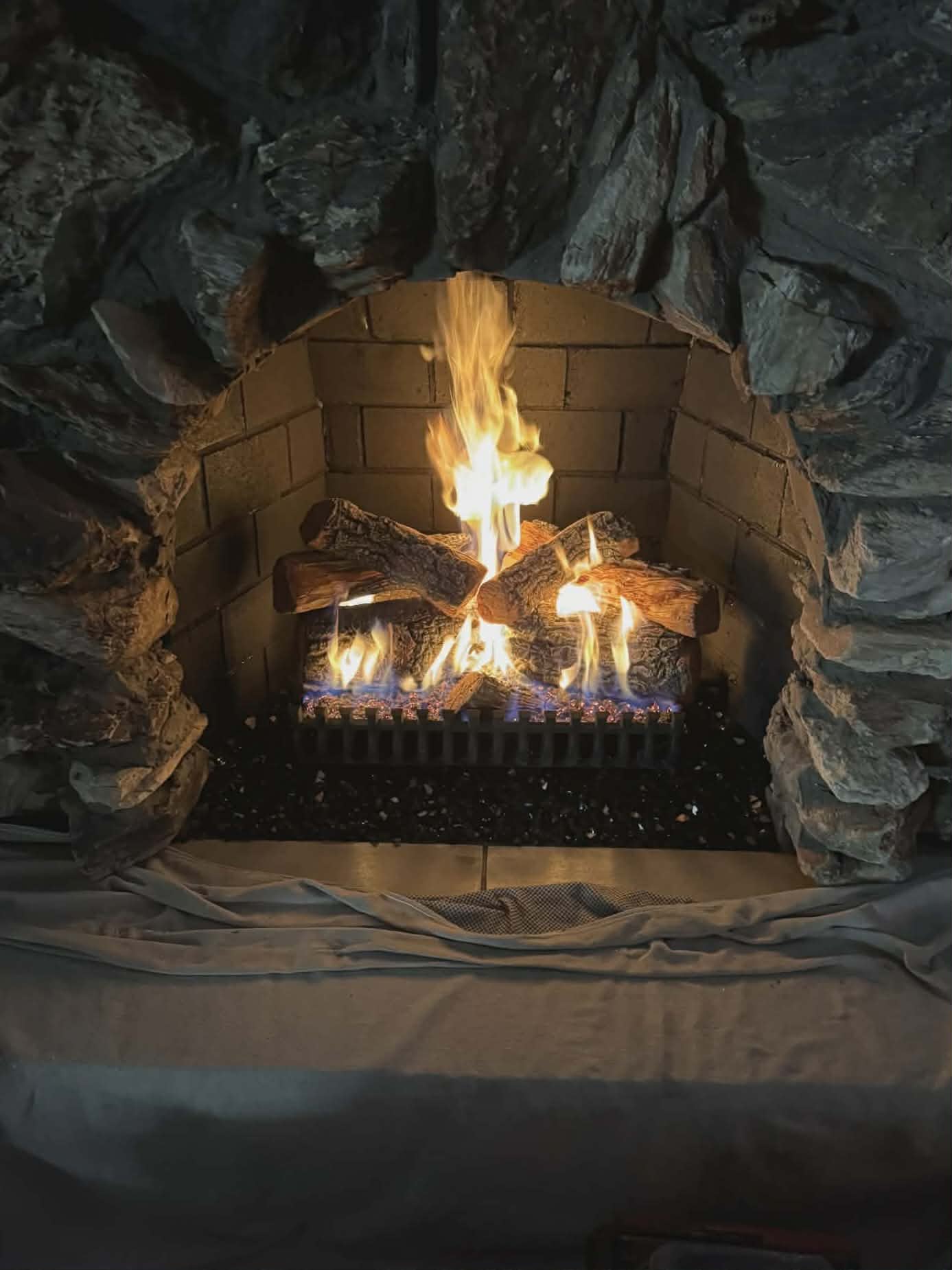 Lit gas logs fireplace