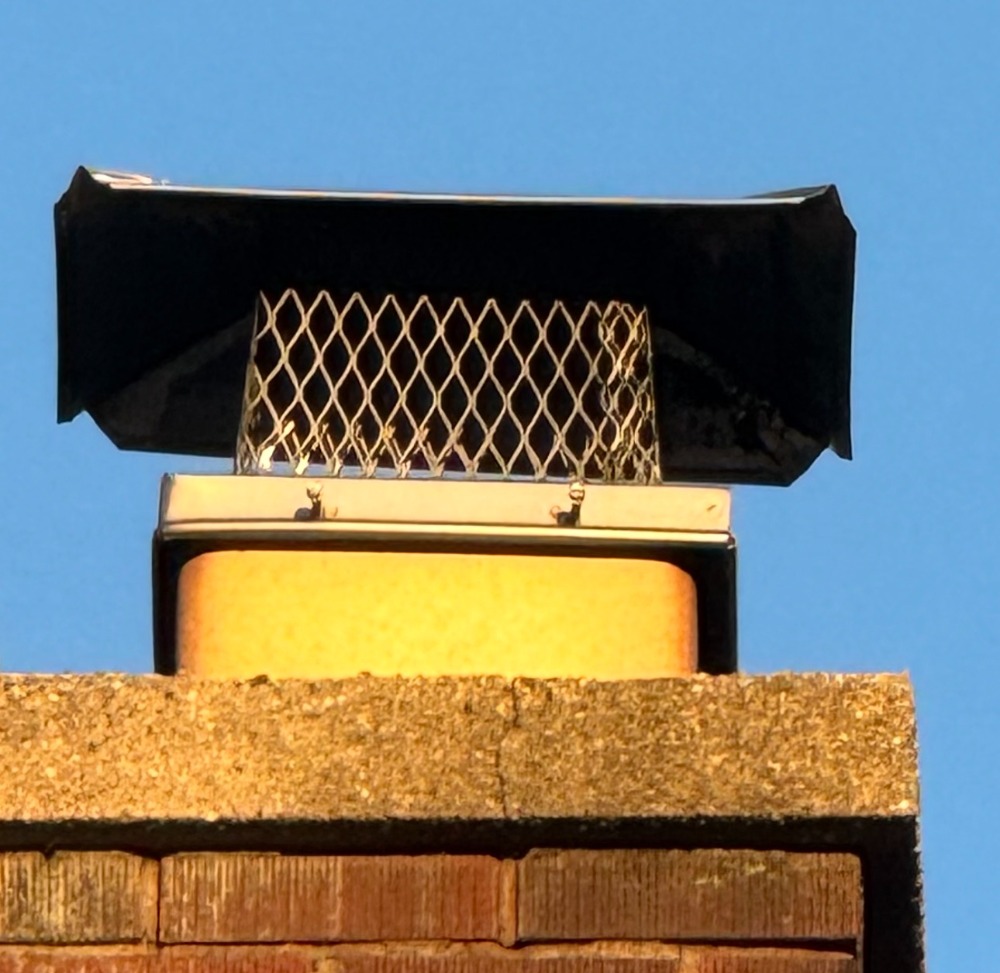 Standard chimney cap on brick chimney