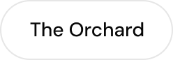 White rounded rectangular button with the text 'The Orchard' centered in black font.