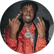 Youtube creator: Smiling man wearing a red jacket and a large silver chain necklace