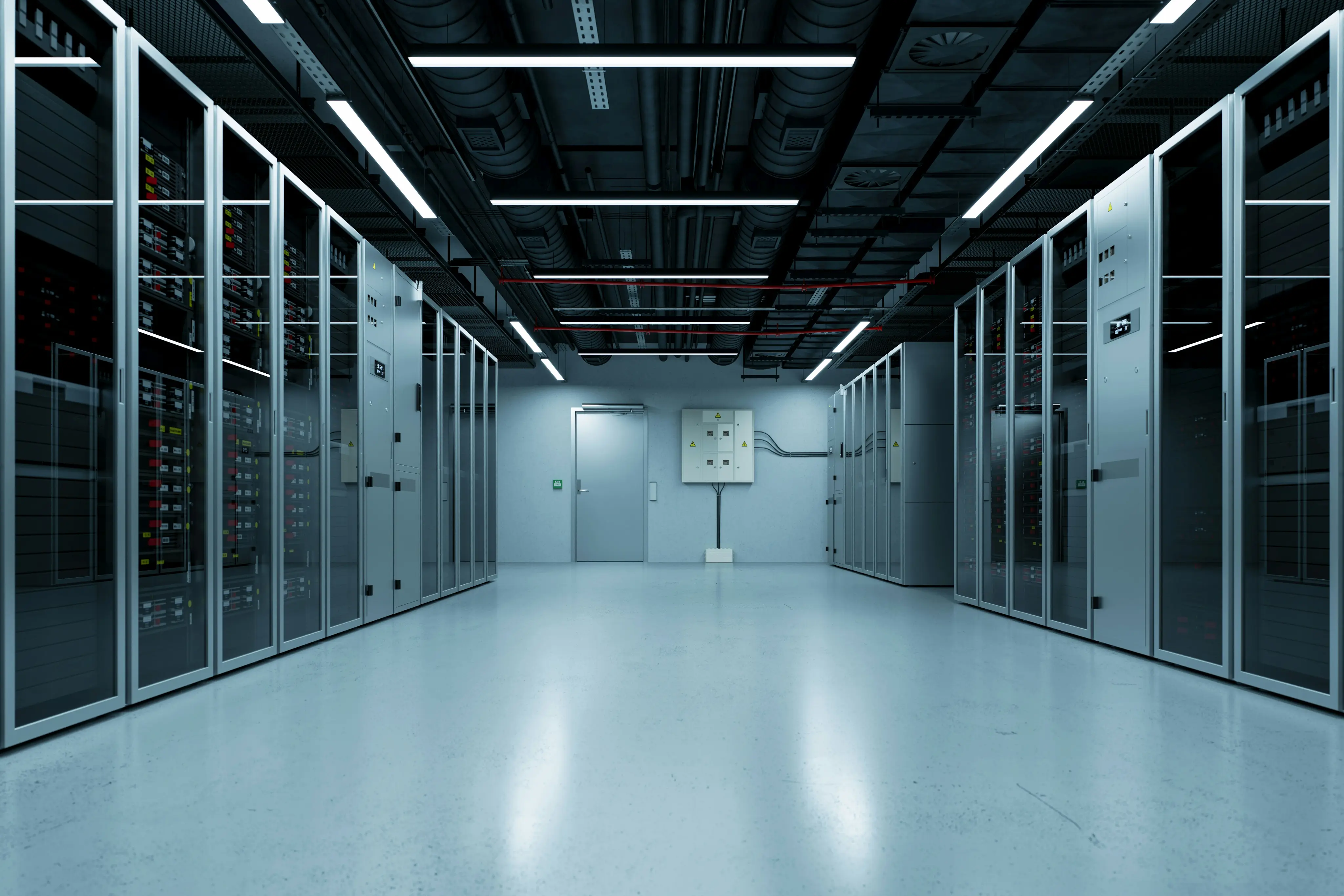 Modern data centre room with rows of server racks and overhead lighting.