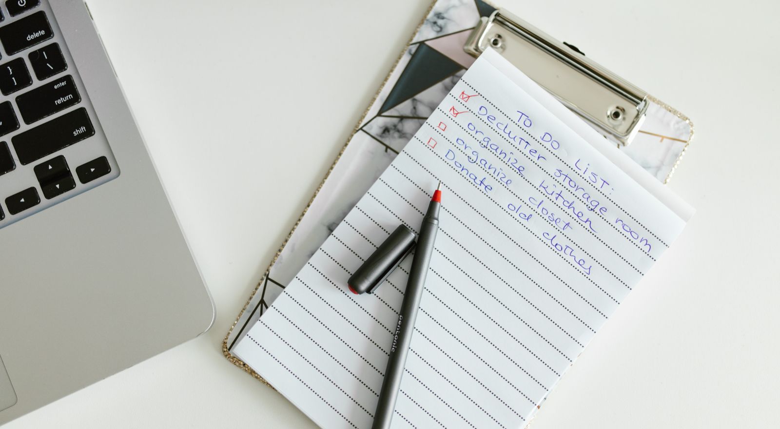 Organized task checklist on a clipboard beside a laptop