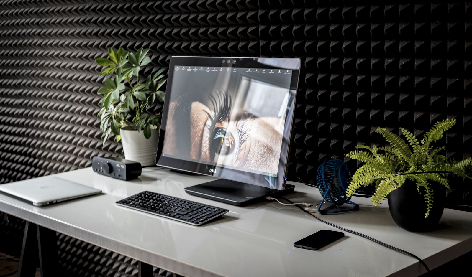 Modern workspace with a monitor displaying a close-up of an eye