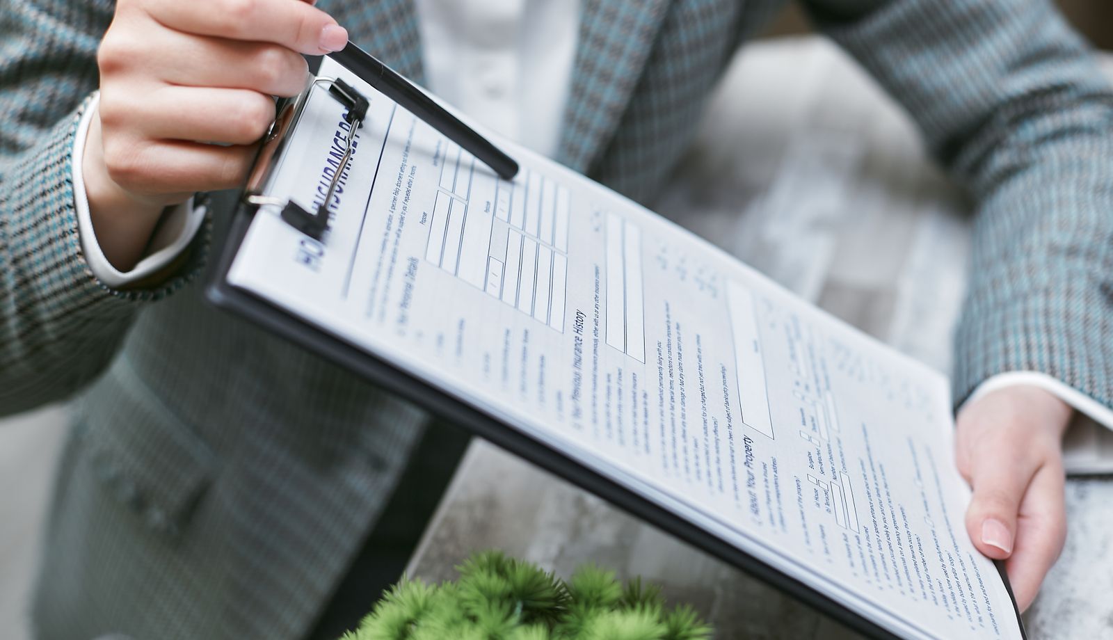 Staff member holding a clipboard with an insurance document