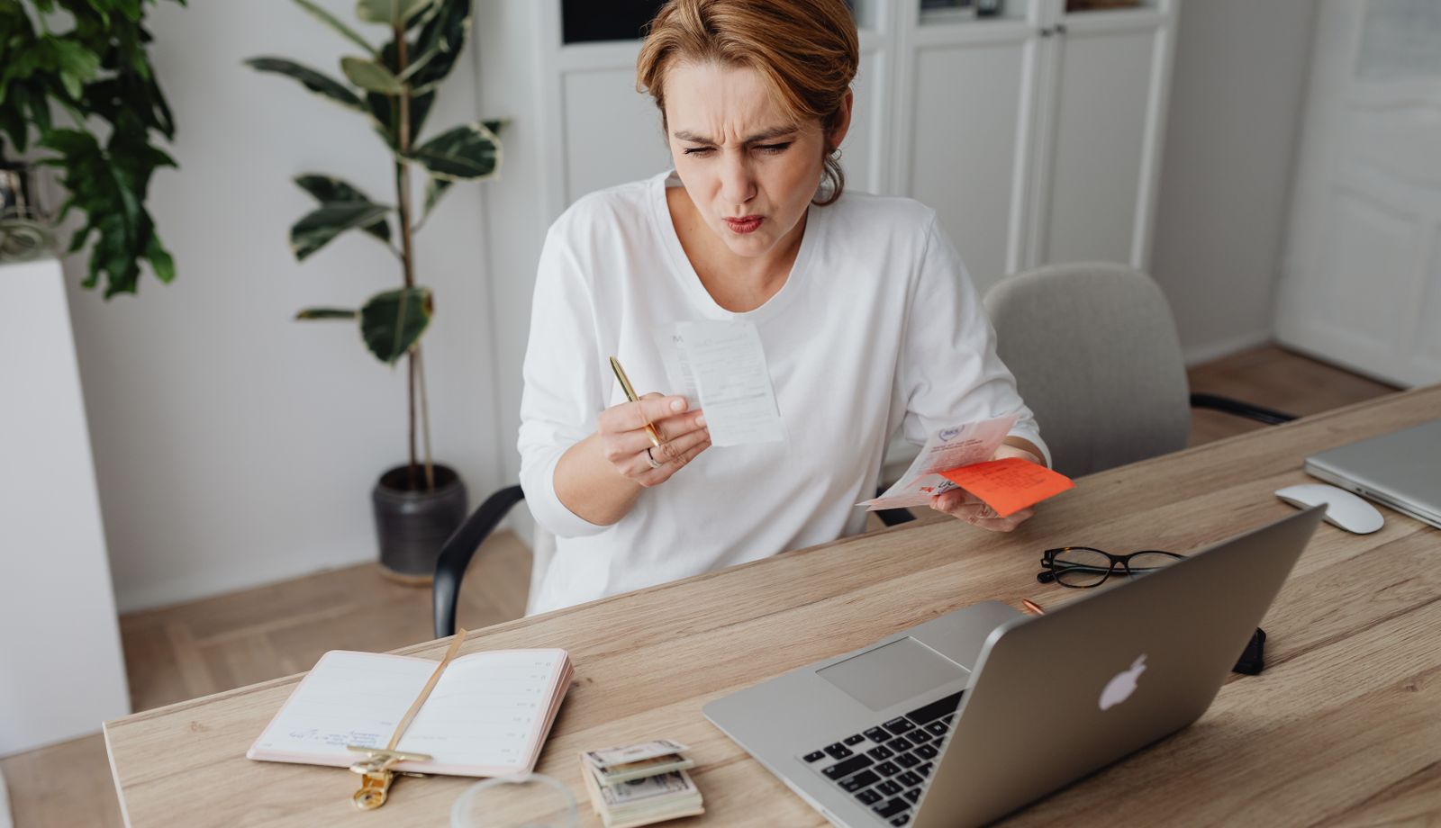 Remote billing specialist reviewing documents at a home office desk