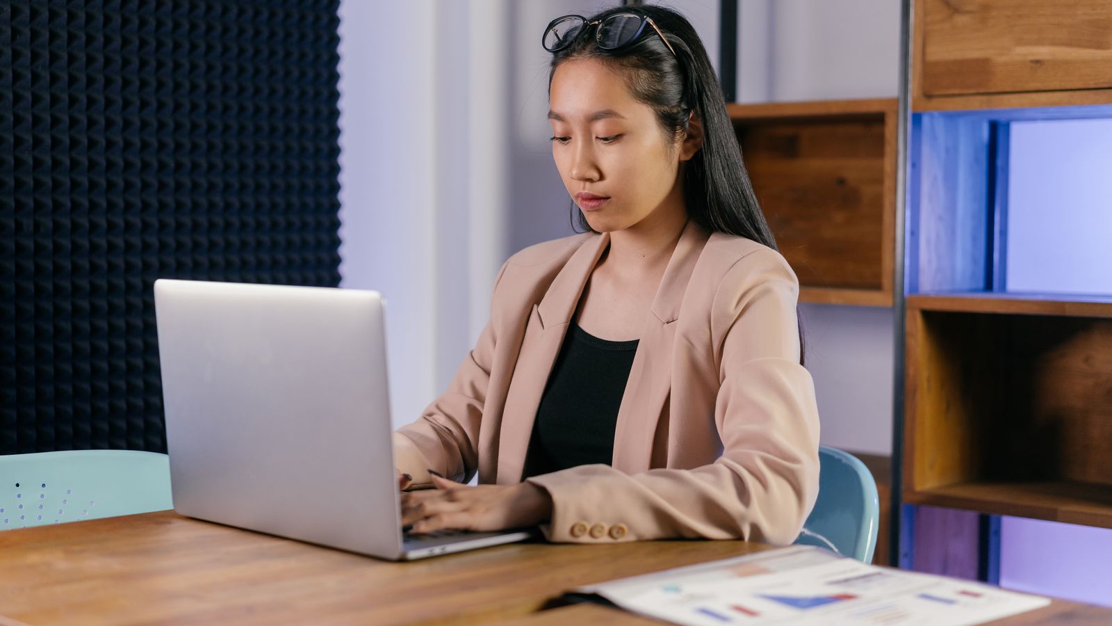 Professional working on a laptop in a bright modern office