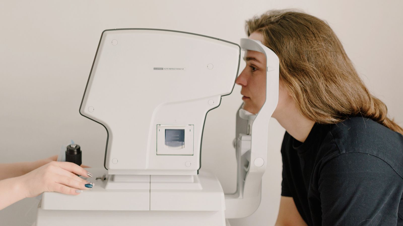 Patient at an autorefractor during a technician workup