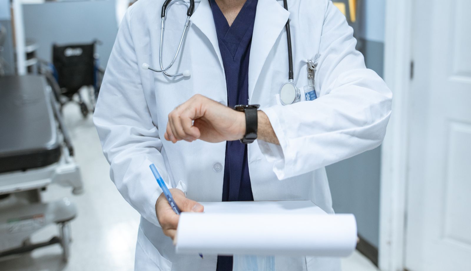 Coordinator checking the time while holding a case chart
