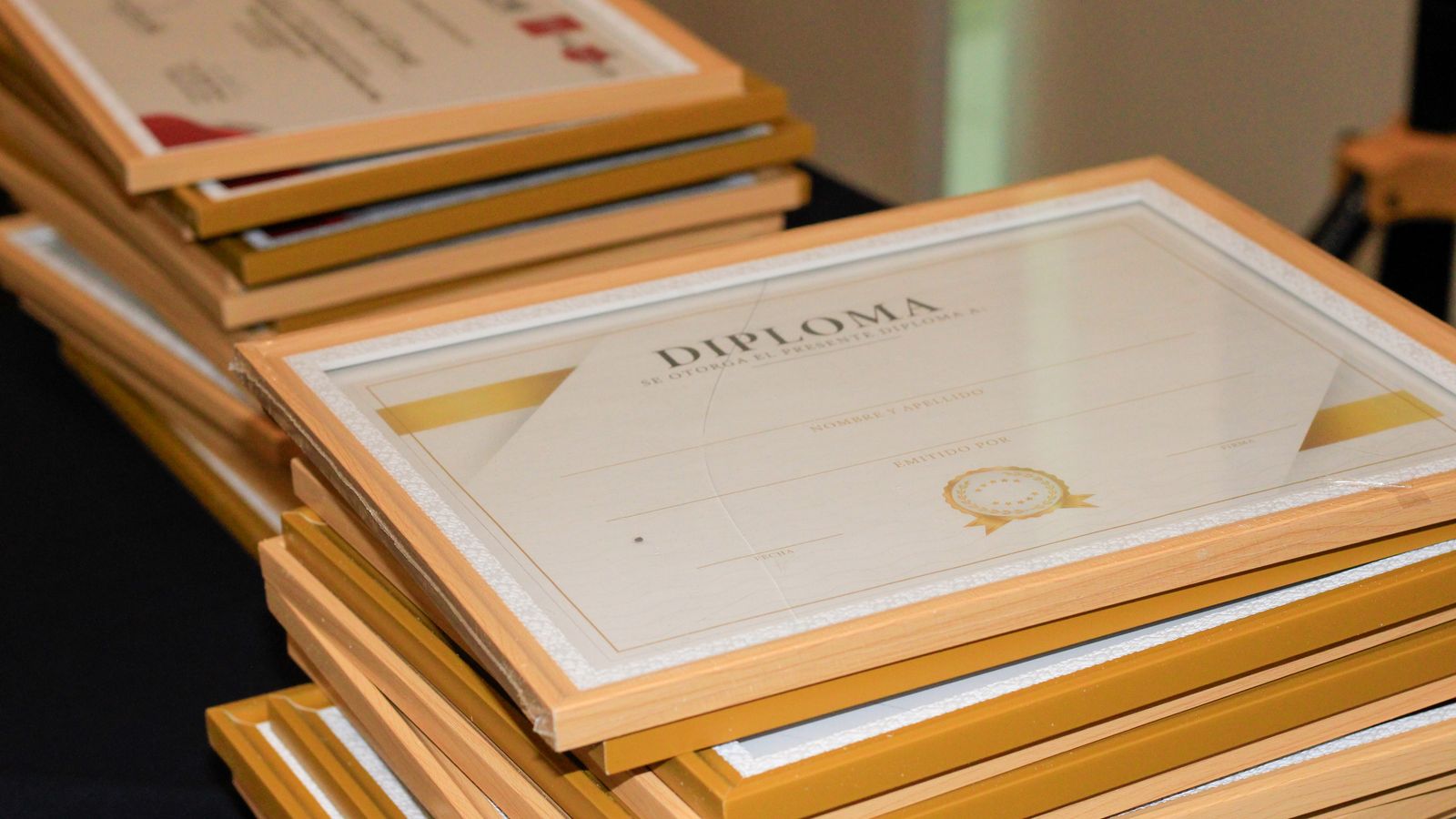 Stack of framed certification diplomas