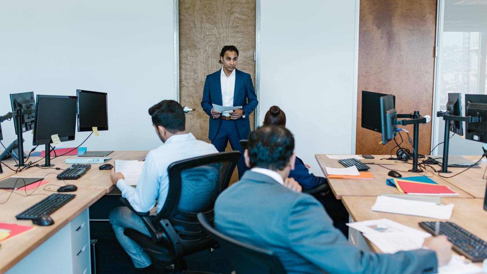Practice manager leading a team meeting in a modern office