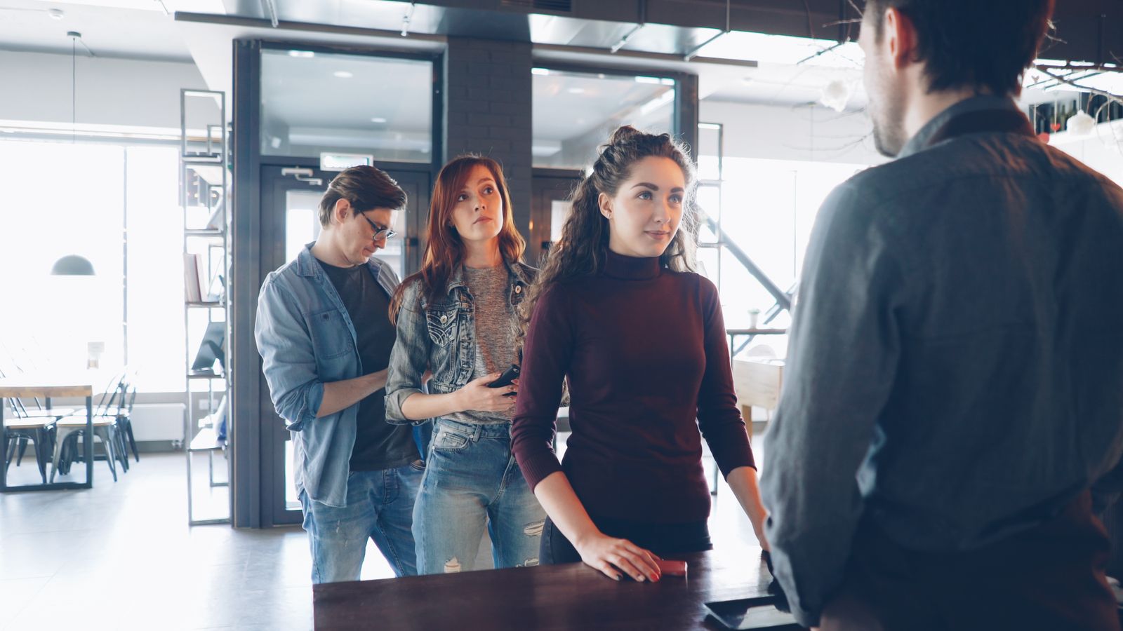 Customers waiting in a line at a service counter