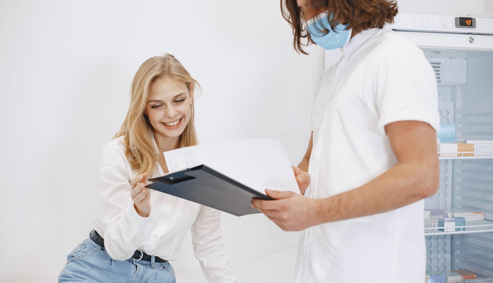 Smiling patient reviewing results with a clinician
