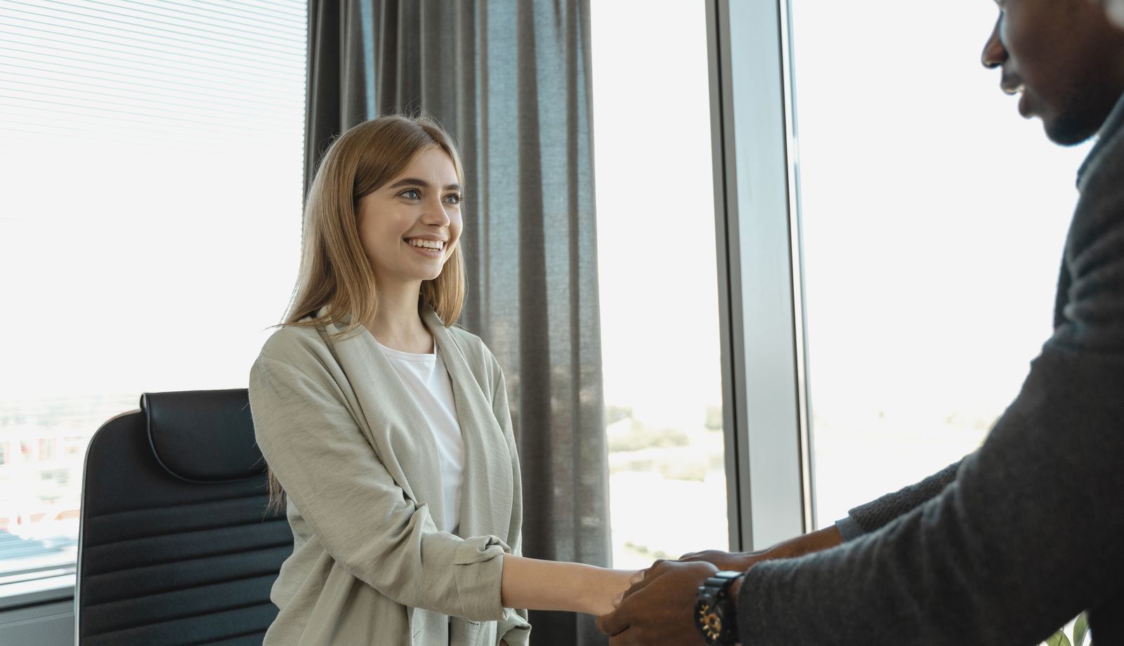 Candidate shaking hands at the start of a staff interview