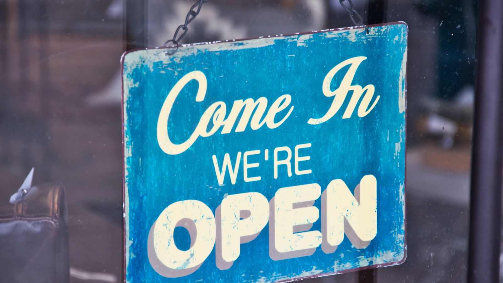 Open sign hanging on a practice front door