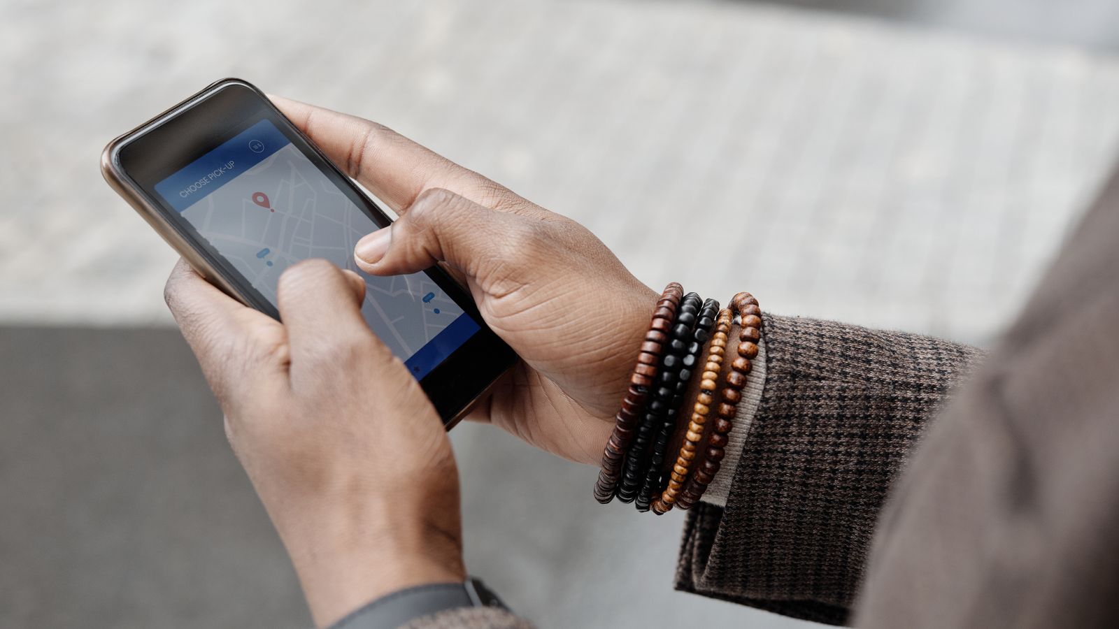 Hands searching a local map on a smartphone