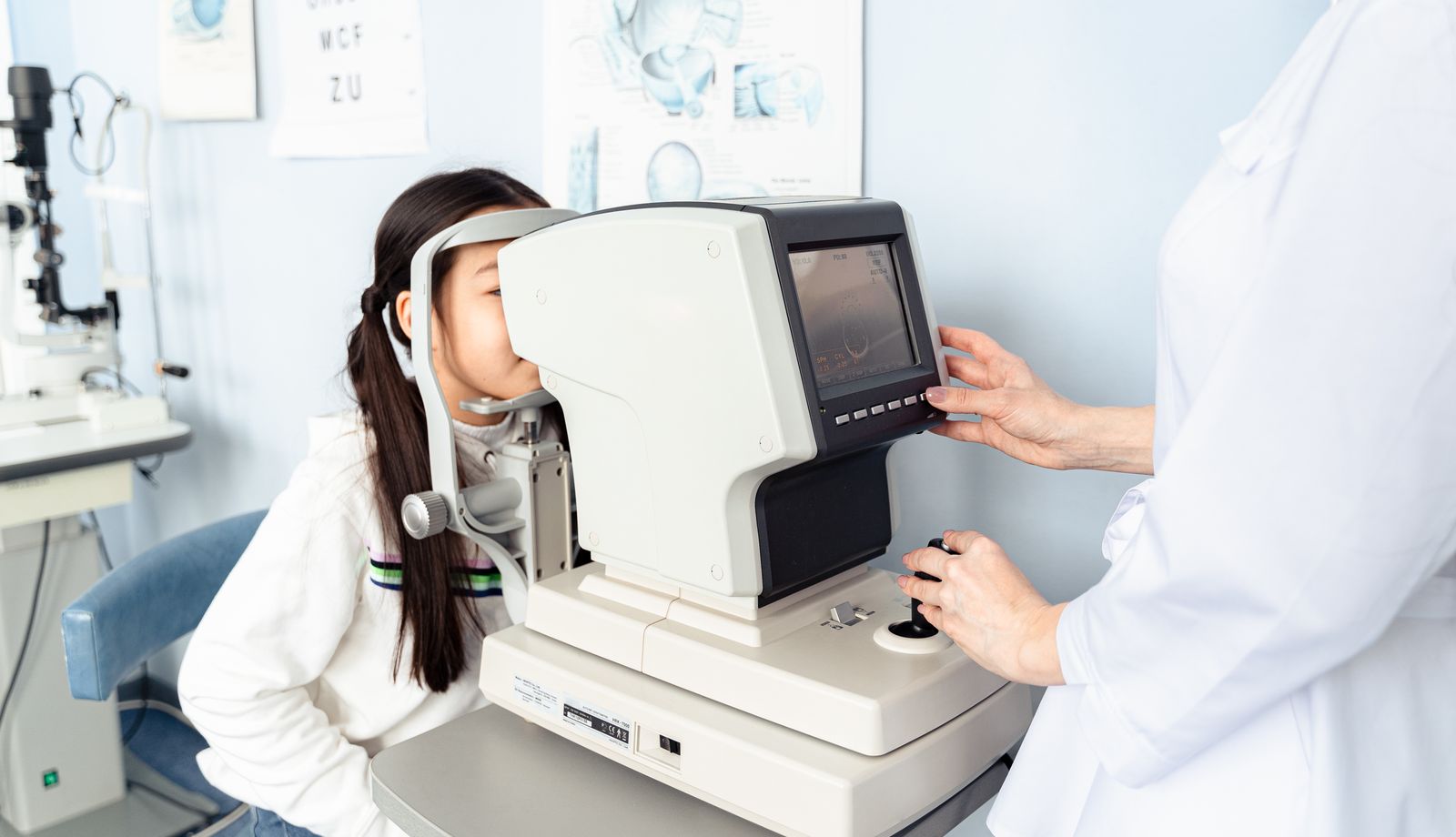 Child having an eye exam with diagnostic equipment at a clinic