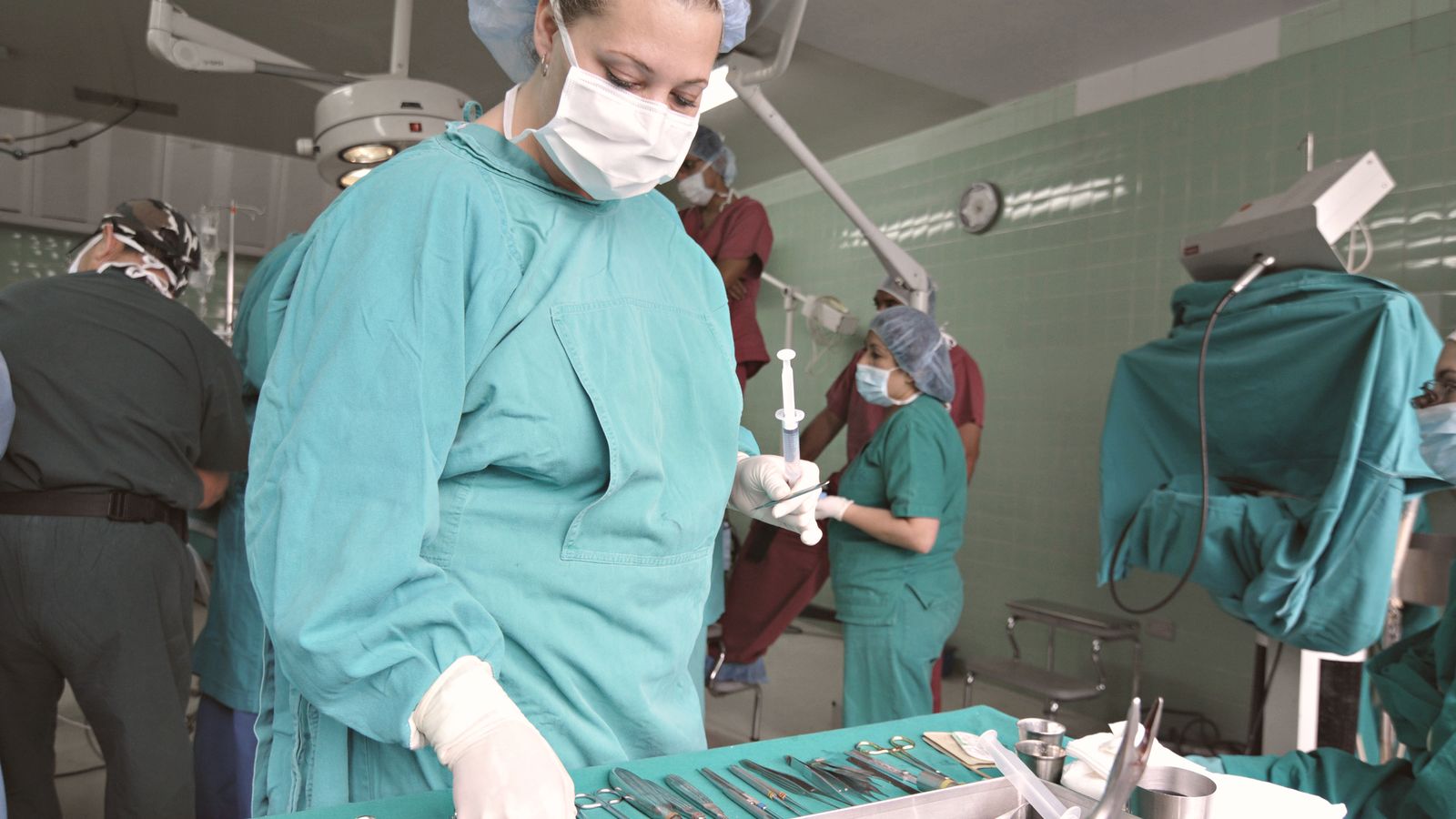 Surgical team preparing instruments in the operating room