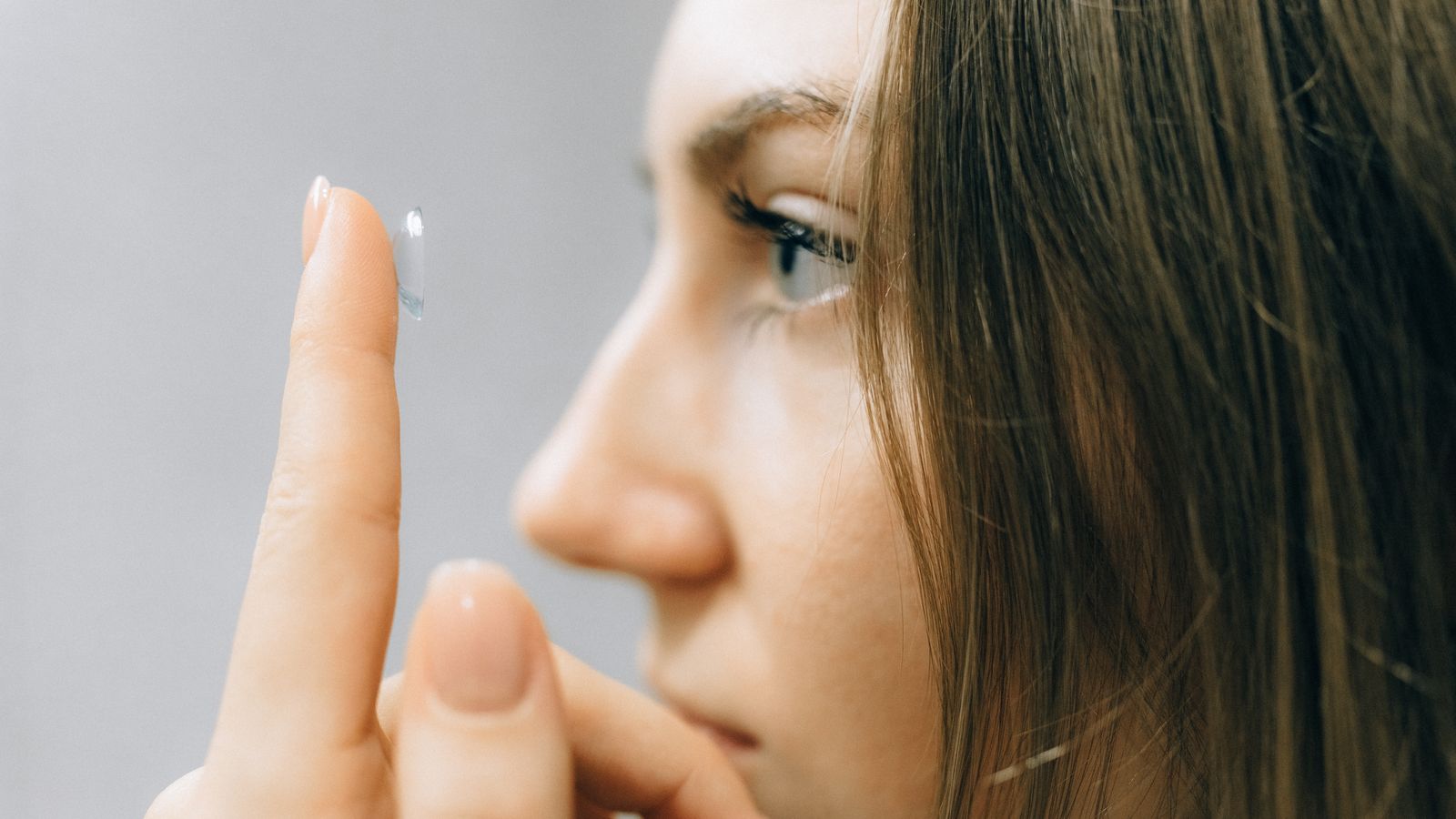 Close-up of a patient placing a specialty contact lens