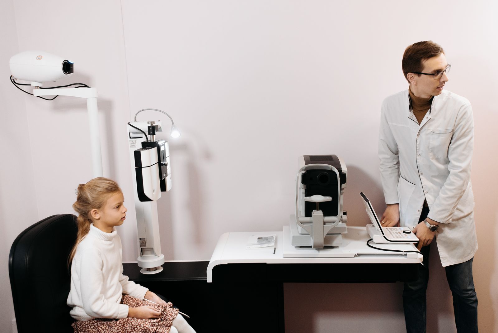 Optometrist walking a patient through an eye exam and next steps