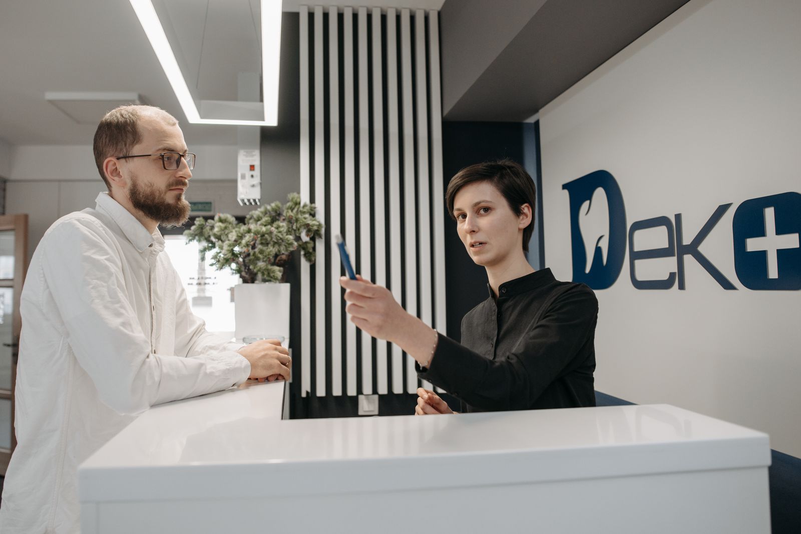 Front desk staff greeting a patient arriving at an eye care office
