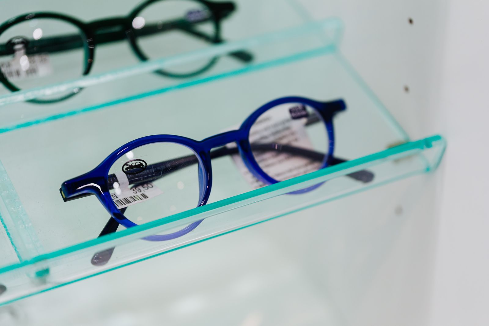 Eyeglasses in a display case at an optical shop front counter