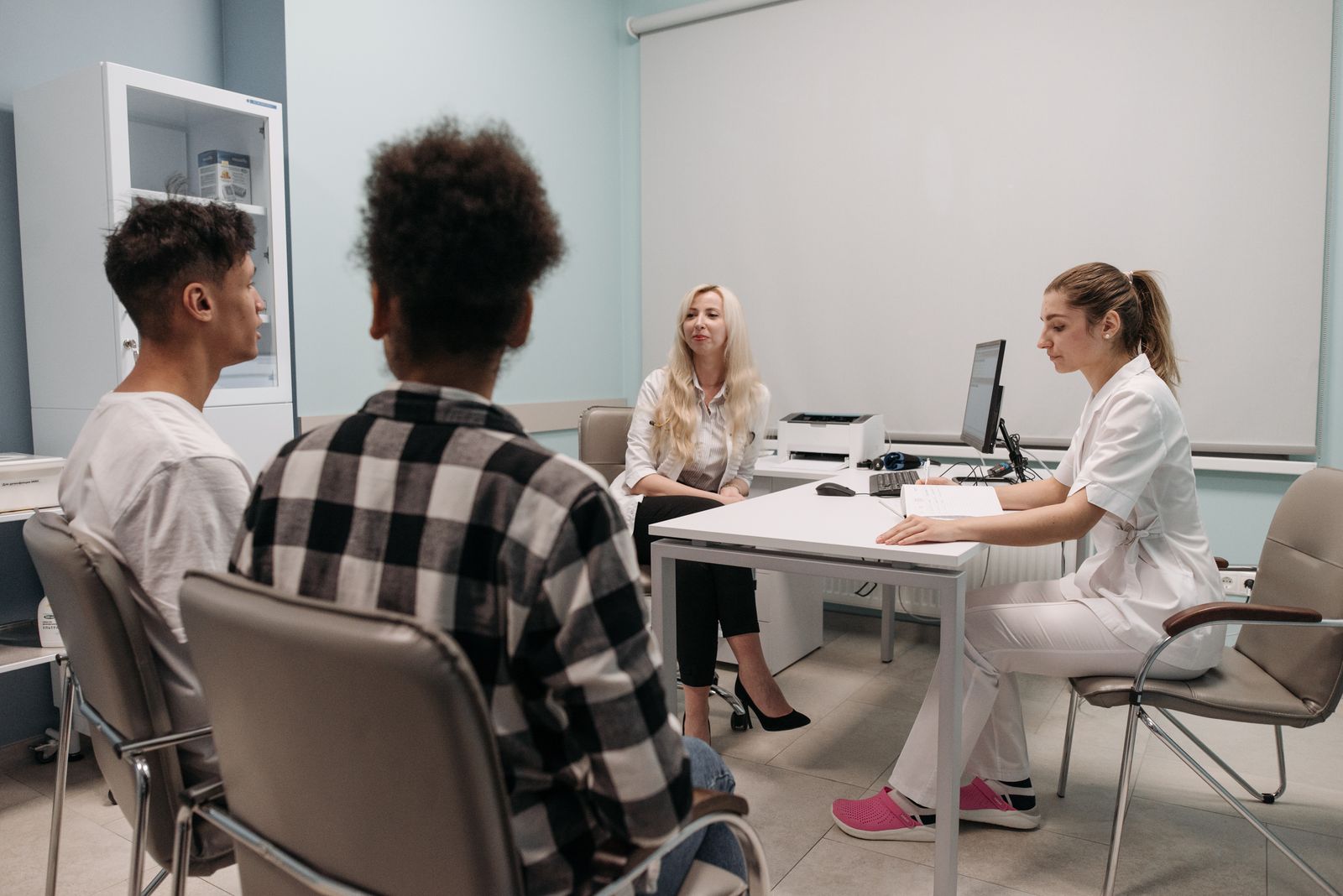 Doctors reviewing practice records during a business meeting