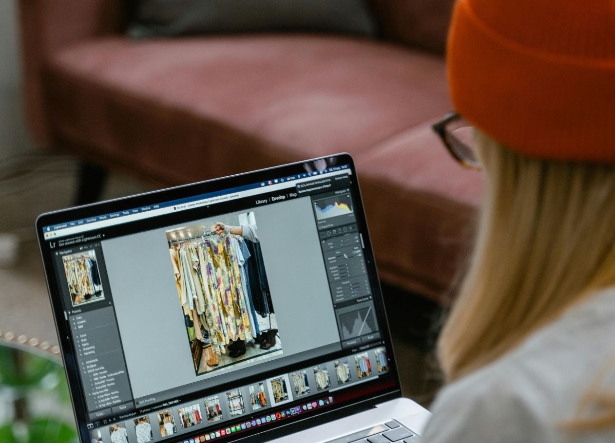 woman with beanie editing video on laptop