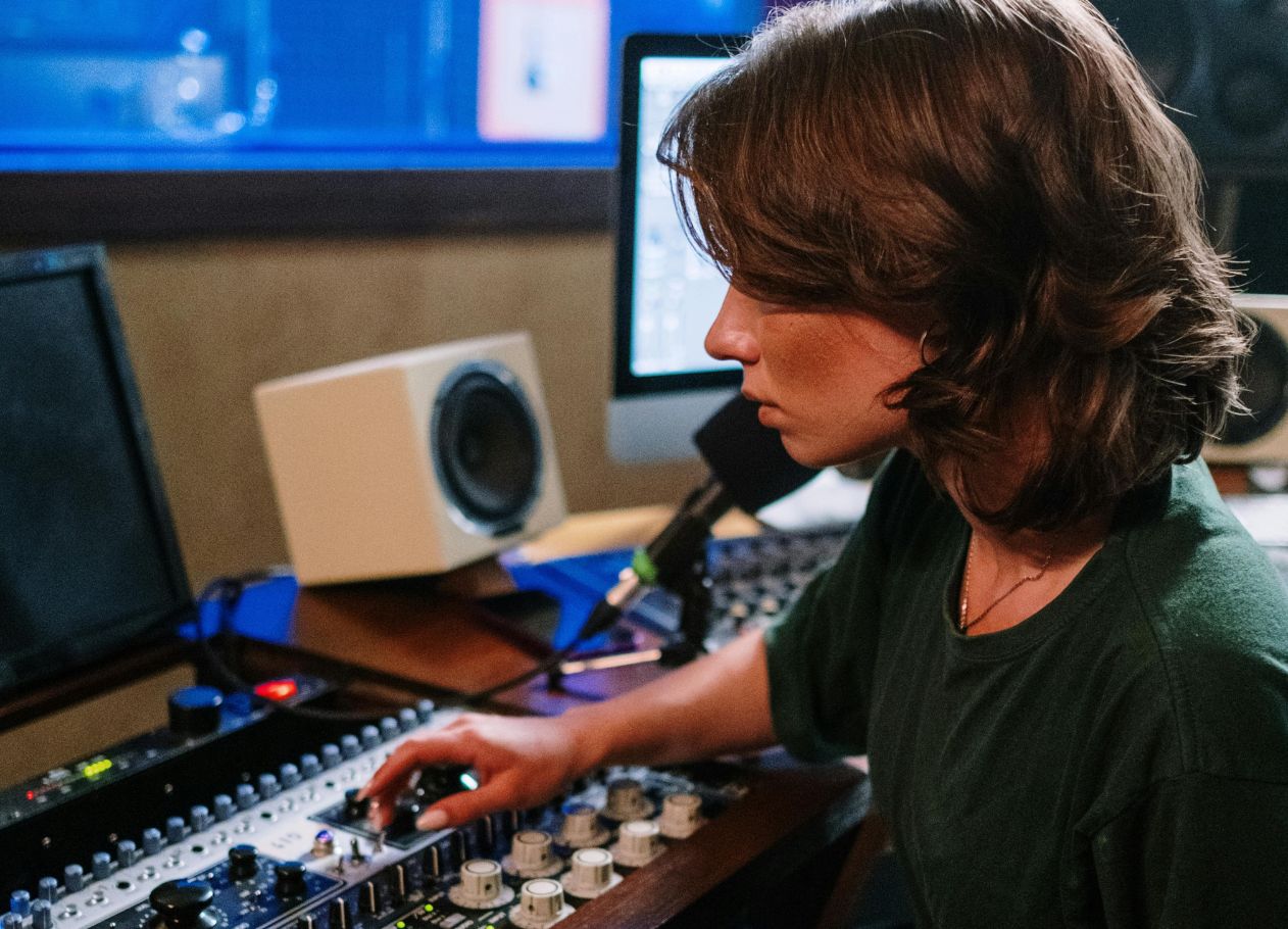 Woman editing audio in a recording studio