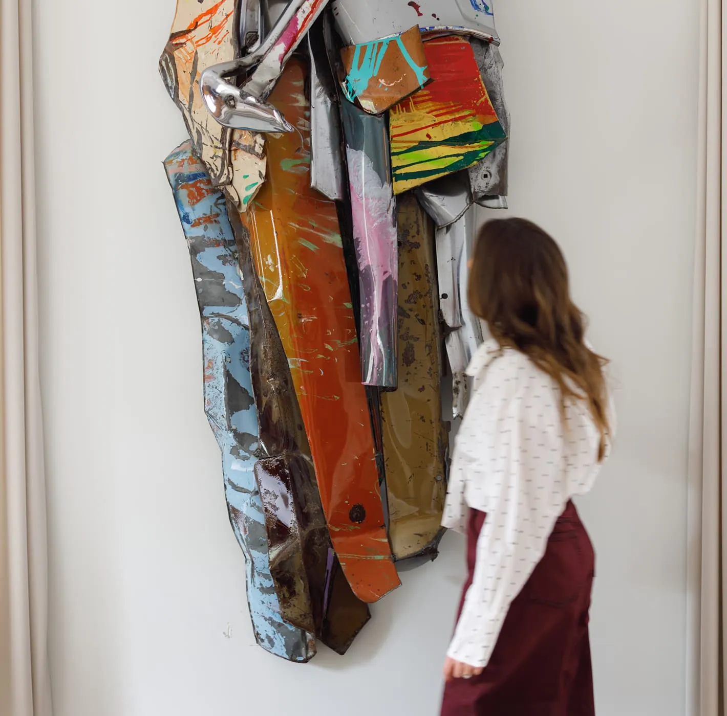 Woman looking at colorful abstract sculpture in a gallery, editorial photography for Alexandra Fairweather.