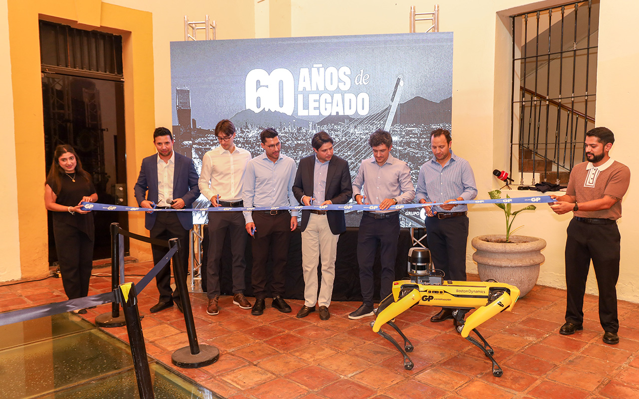 Corte de listón por los 60 años de legado, con un robot cuadrúpedo al frente.