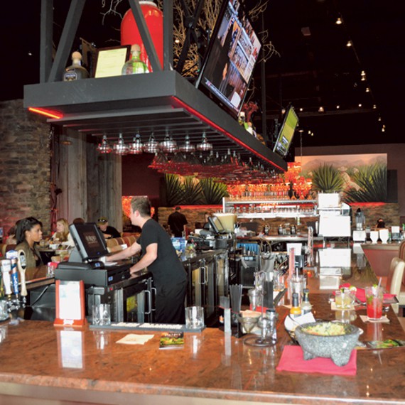 Polished brown granite kitchen countertop with drinks and bar accessories
