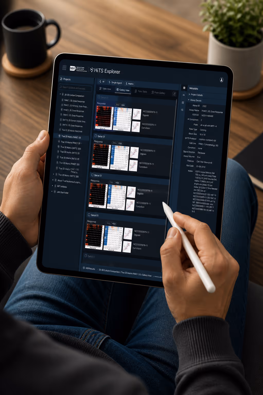 Person using a stylus to interact with NIH HiTS Explorer app displayed on a tablet.