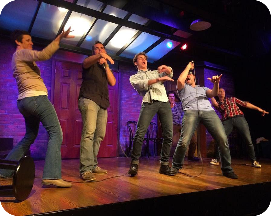 A group of improv performers onstage.