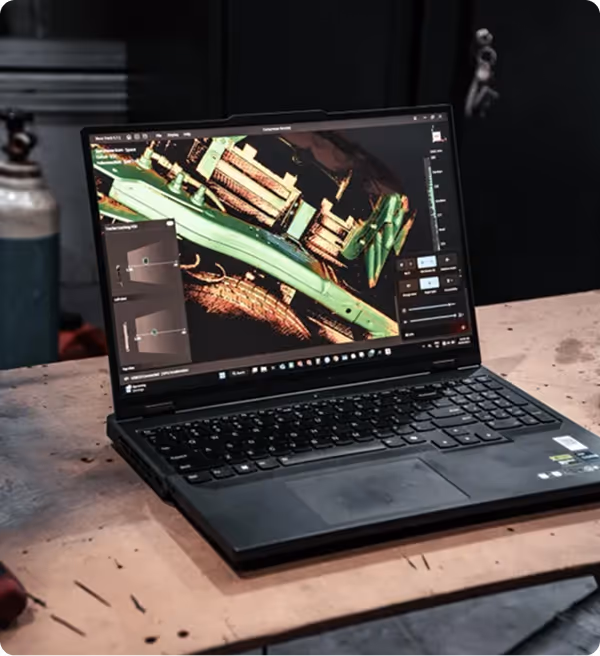 Laptop on a wooden table displaying 3D modeling or scanning software with a detailed object in green and brown tones.