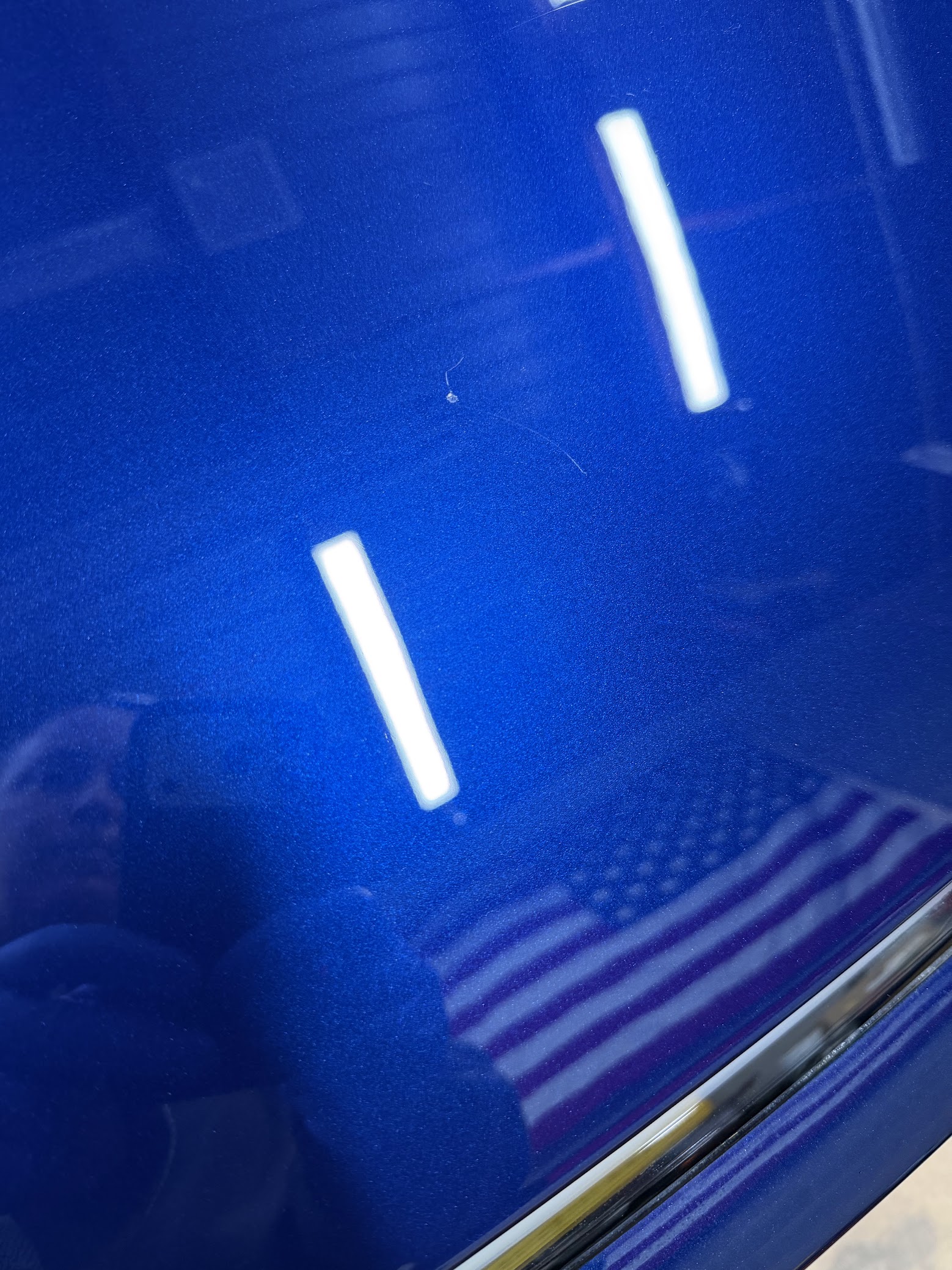 Blue Tesla with high-gloss paint shine after Revivify coating at Dynamite Details