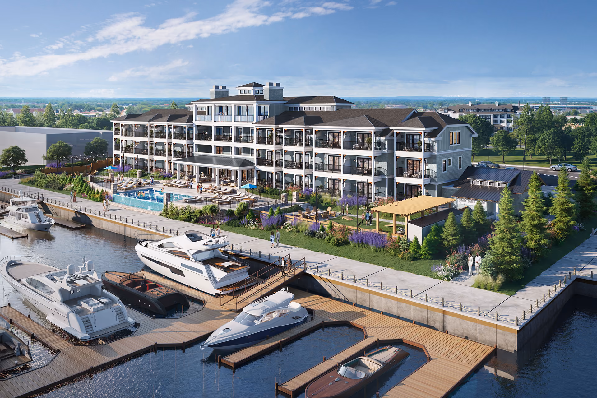 Modern waterfront residential building with multiple balconies, a pool area, landscaped gardens, and docked luxury boats.