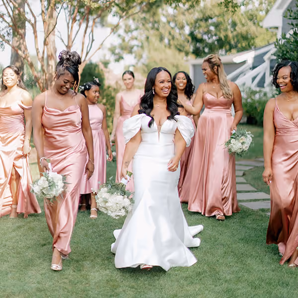 Bride with her bridesmaids in rose-pink dresses on the lawn at Chesapeake Bay Beach Club