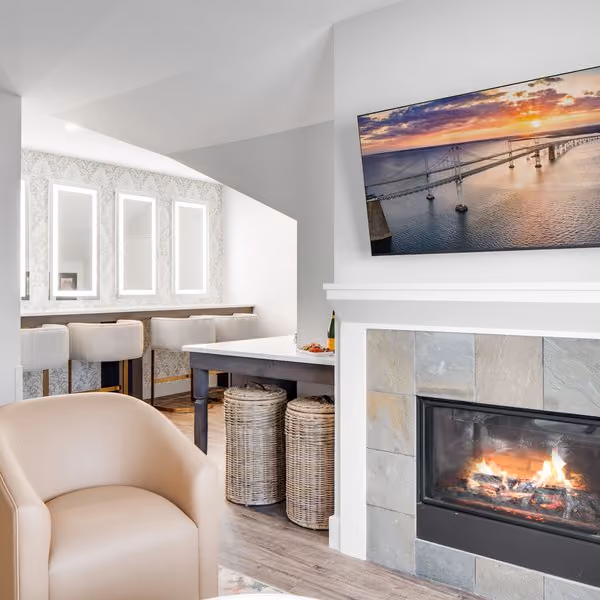 Veranda Suite living area with a tiled fireplace and Bay Bridge artwork at The Inn