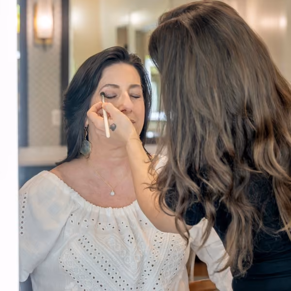 Makeup artist applying eye makeup to a client at The Spa