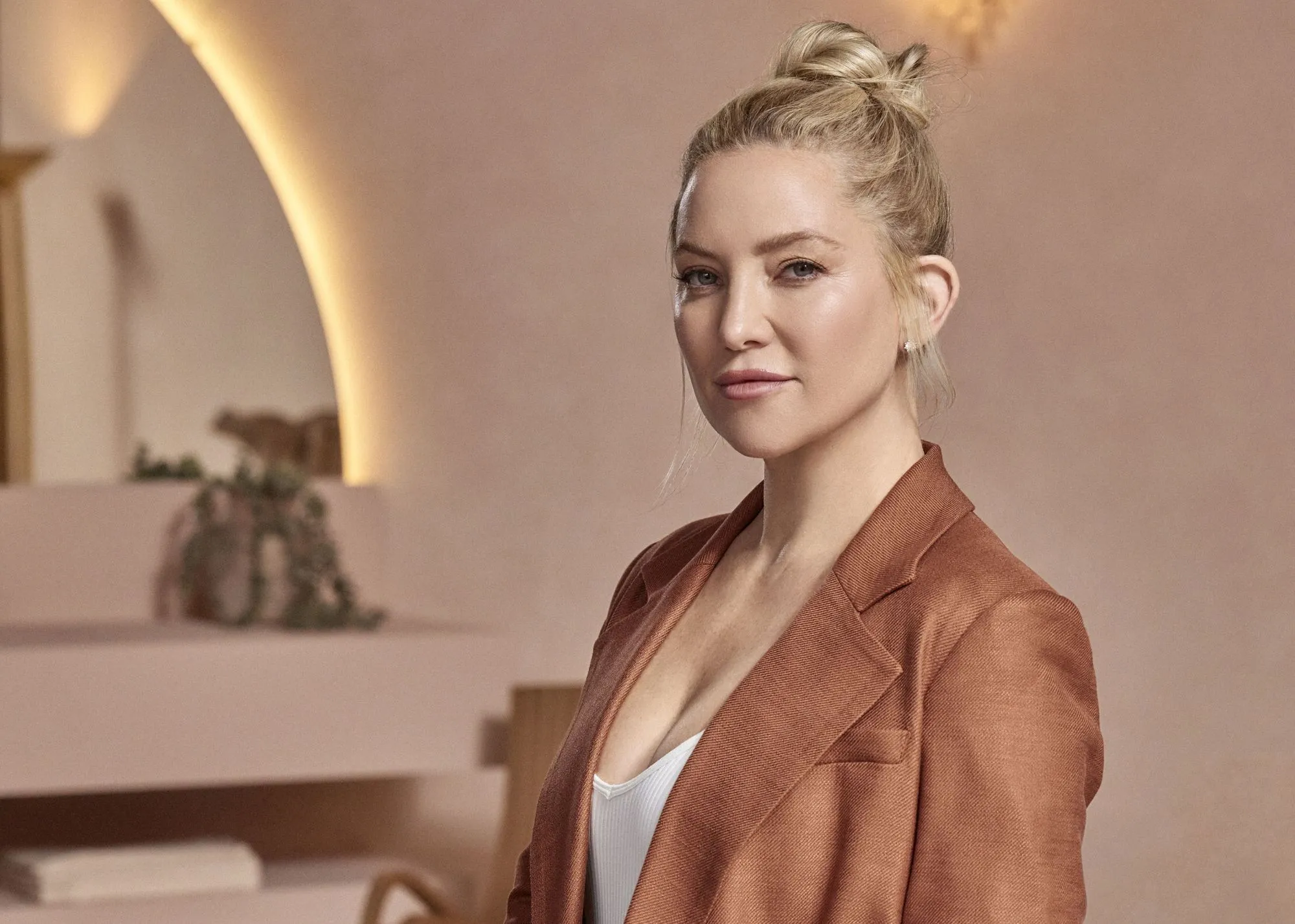 A woman standing in front of a mirror in a room.