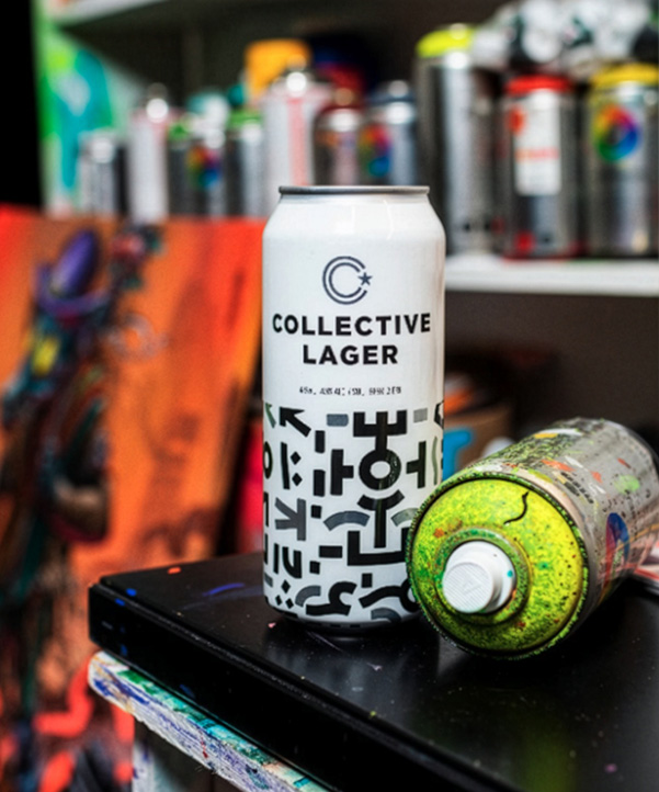 Collective Arts studio photo with spray paint cans and a Collective Arts can